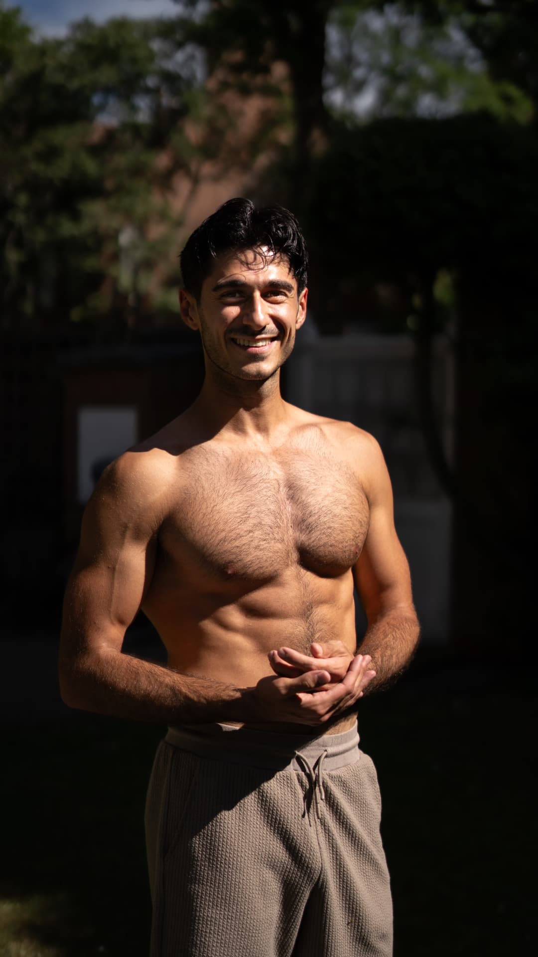 Editorial portrait of Ade outdoors in dappled sunlight