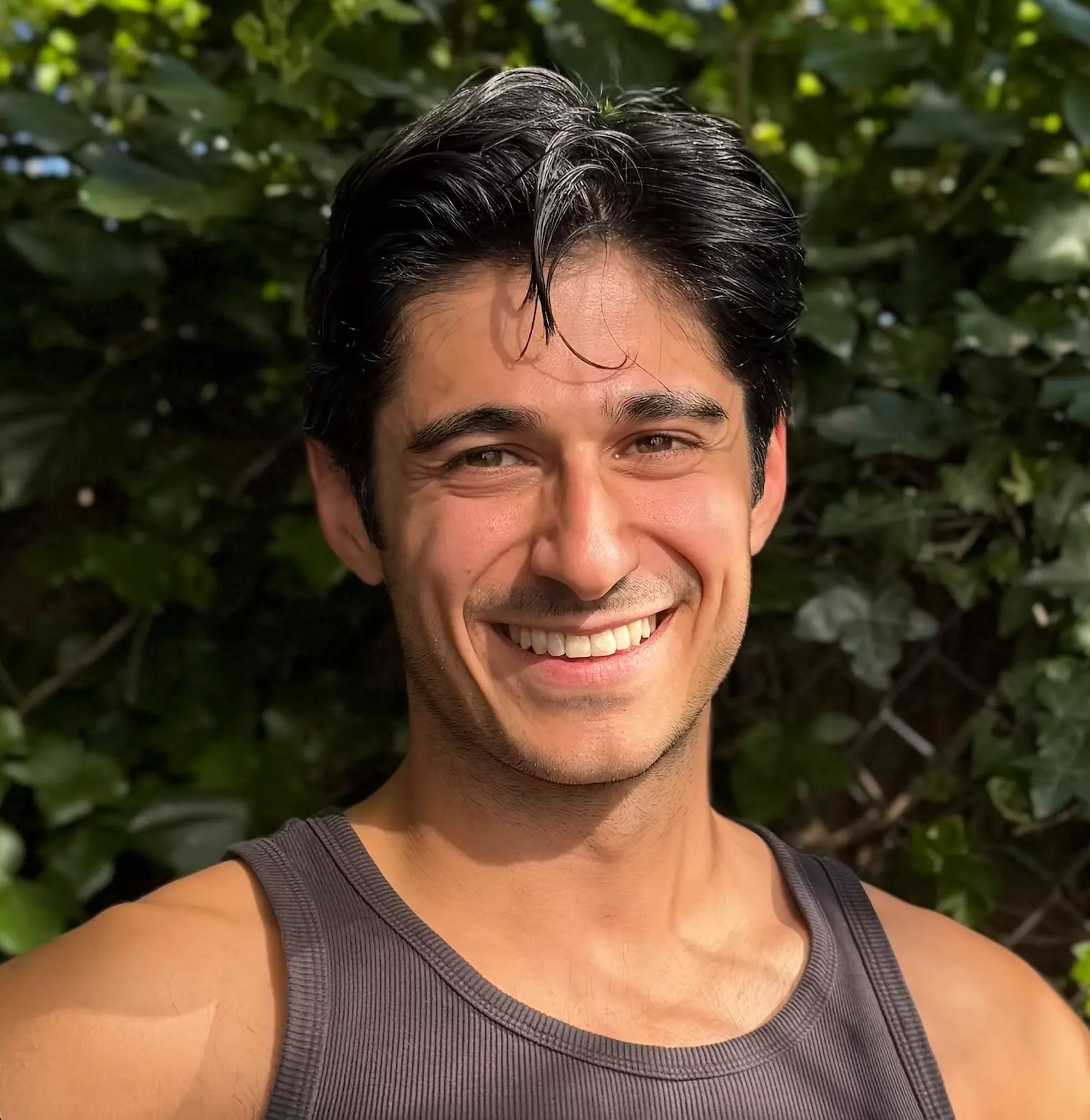 Ade smiling outdoors